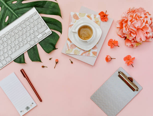 istock Flat Lay Minimal tropic background with monstera leaf,  coffee cup,  keyboard, notebook, flower on pink pastel background. Blogger concept 1314244674