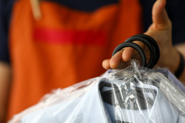 istock Clothes dry cleaning service worker returning shirts to customer 1314248823