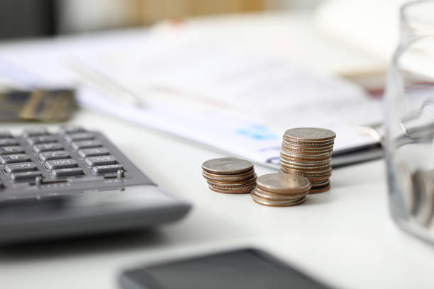 Pile of metal change lying down at workplace as symbol of financial success or profitable job close-up