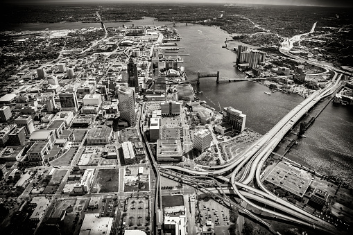 Aerial view of the beautiful city of Jacksonville Florida along the St. Johns River from an altitude of about 1000 feet over the river in black and white and toned in a light sepia for effect.