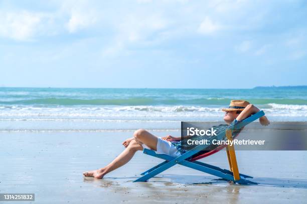 Asian Man Resting On Beach Chair On The Beach At Summer Sunny Day Stock Photo - Download Image Now