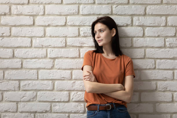 istock Ambitious young lady stand by wall cross arms look away 1314252993