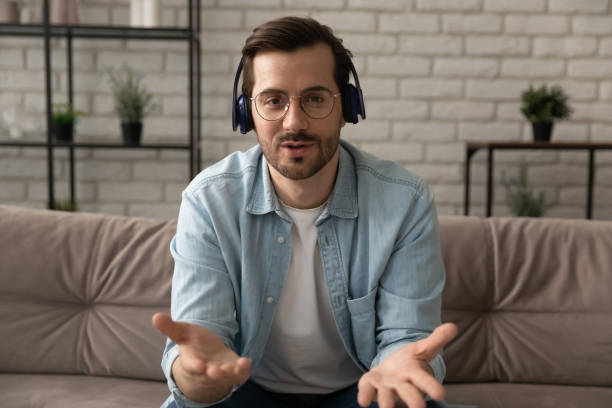 istock Confident millennial man tutor wearing headset talk give remote lesson 1314253014