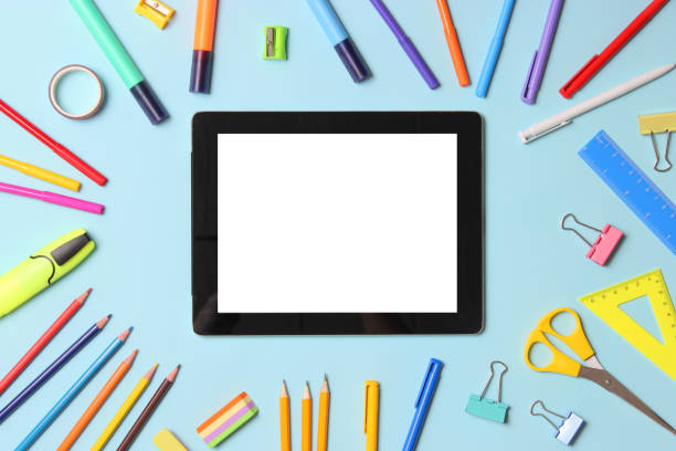 istock Modern digital tablet and school stationery on a colored background top view. 1314253790