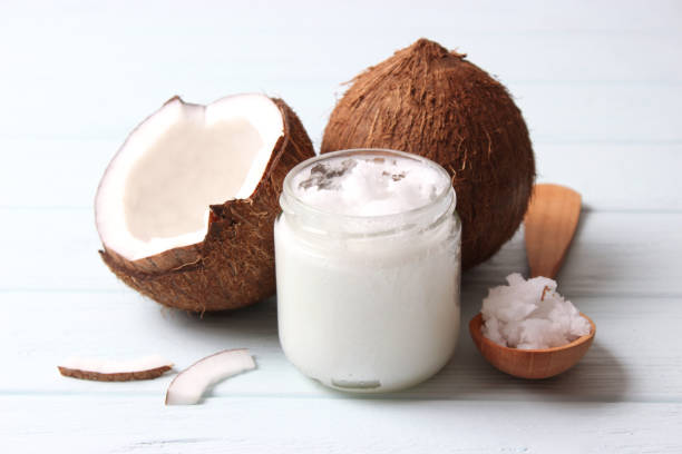 istock coconut oil and coconuts, palm branches close up 1314254455