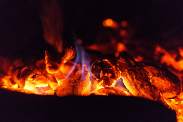 close up of campfire burning wood hot red with blue little flame - blue flame natural gas fireplace imagens e fotografias de stock