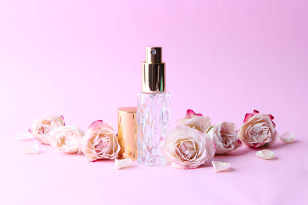 istock Perfume bottle and rose flowers on a light background close up 1314256369