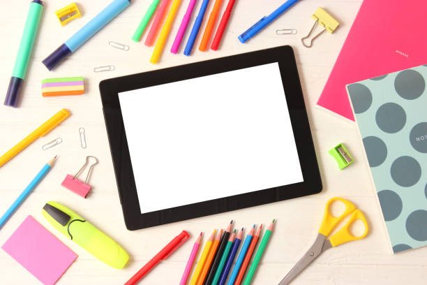 istock Modern digital tablet and school stationery on a colored background top view. 1314258193