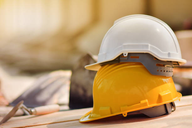 istock helmet hard hat  on wood floor in constriction site 1314259340
