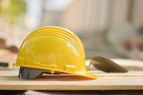 istock helmet hard hat  on wood floor in constriction site 1314259384