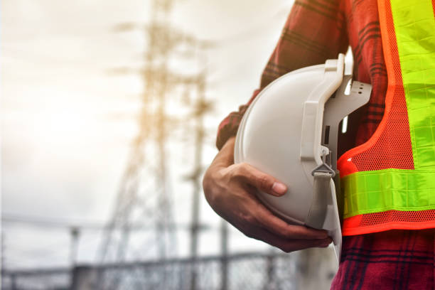 istock Technician holding white hat safety hard hat sunlight background 1314259497