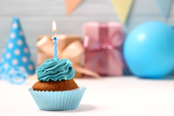 istock Delicious cupcake with a candle on a colored background 1314260281