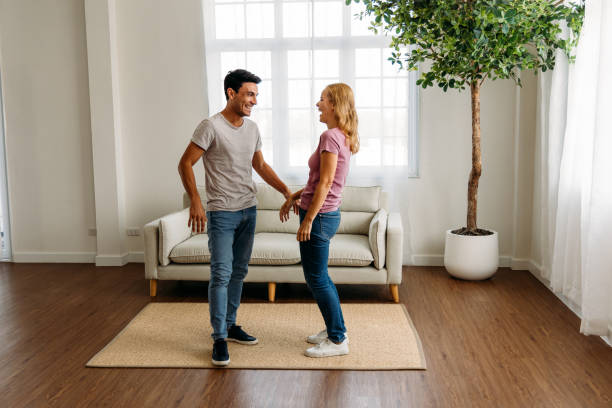 istock Young couple standing and laughing together 1314260367