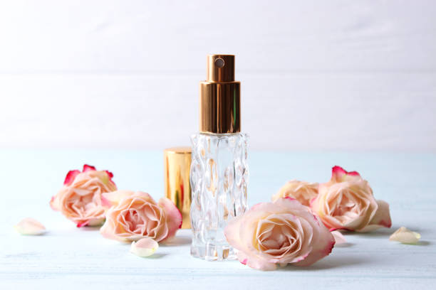 istock Perfume bottle and rose flowers on a light background close up 1314262299