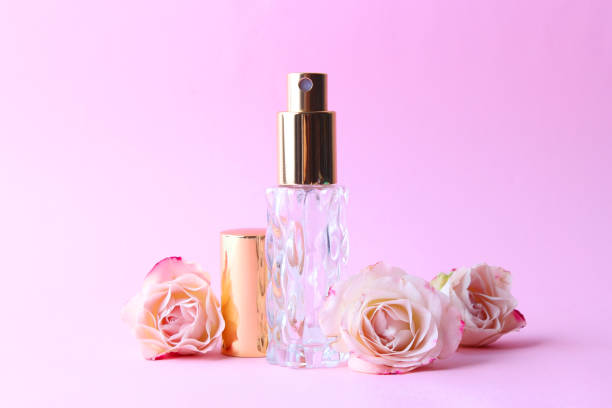 istock Perfume bottle and rose flowers on a light background close up 1314265781