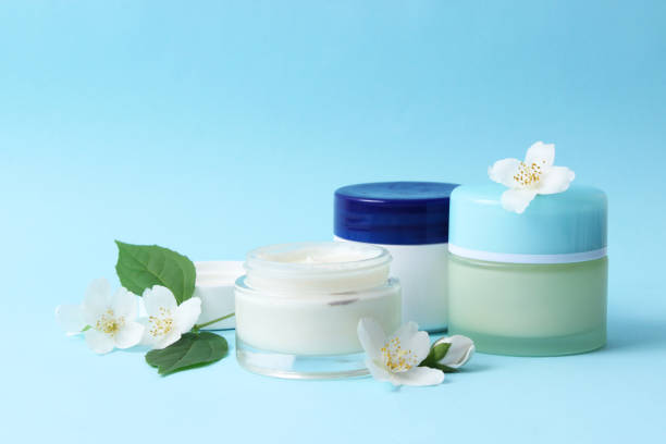 istock cosmetic cream and flowers on a colored background close-up. 1314266841