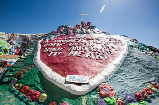 Niland, California - April 17, 2016:  Salvation Mountain is a man made hill in the Colorado Desert, north of Calipatria, northeast of Niland near Slab City, several miles from the Salton Sea. It is in Imperial County, California. It was envisioned and built by Leonard Knight who built it over 20 years. He built it in response to a message he felt he had heard from God. Leonard died about three years before these photos were taken. He was 82.