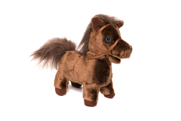 istock Brown fluffy horse toy isolated on white. 1314270103