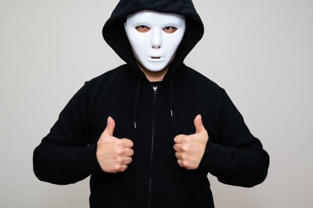 istock Hacker with blank mask showing thumbs up 1314270241