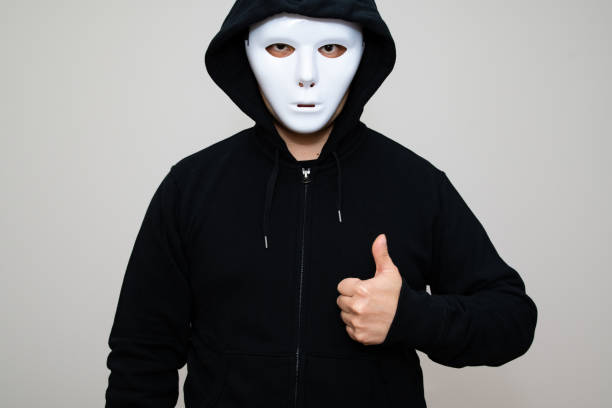 istock Hacker with blank mask showing thumbs up 1314270260