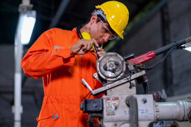 istock Factory worker man use tool to fix and maintenance part of robotic machine in workplace area 1314271287