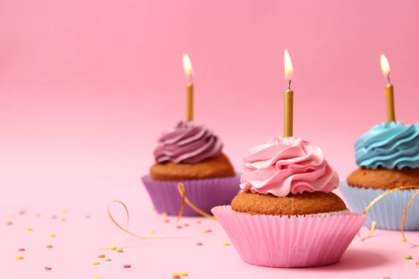 istock Delicious cupcake with a candle on a colored background 1314273129