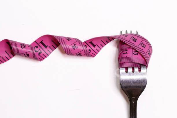 istock A Pink Tape Measure Wrapped Around A Fork 1314275472