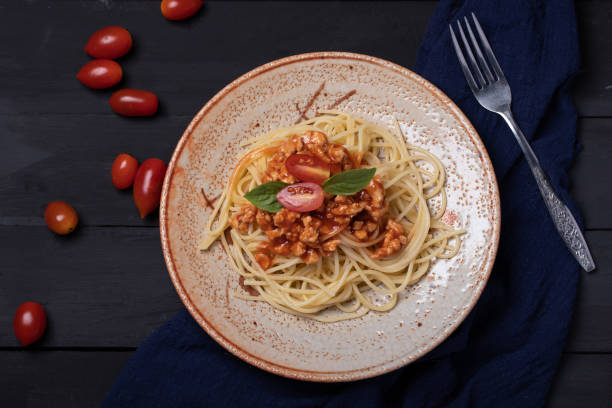 istock Fried spaghetti with chicken sauce in black background plate 1314275682