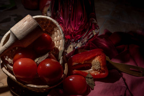istock Ripe tomatoes in a wicker basket on a wooden table. 1314279102