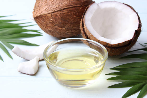 istock coconut oil and coconuts, palm branches close up 1314279125