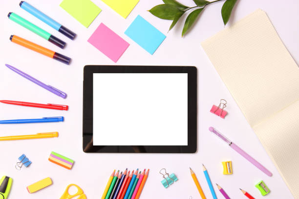 istock Modern digital tablet and school stationery on a colored background top view. 1314280479