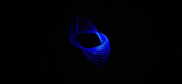 istock Closeup of Neon Blue Spirograph geometric abstract pattern isolated in a Black background. Chakra. Light painting. 1314285494