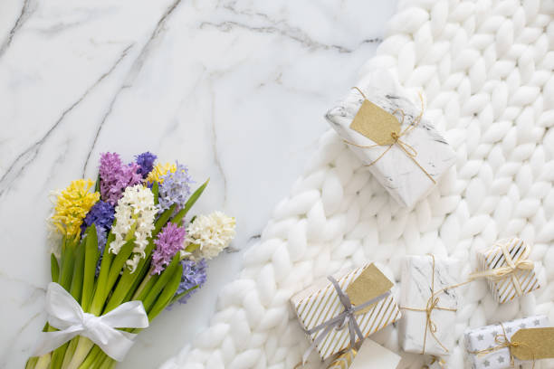 istock Top view trendy composition with festive wrapped gift boxes ribbon bow decorated by bloom flowers 1314285638