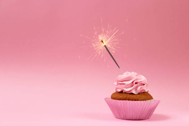 istock Delicious cupcake with a candle on a colored background with space for text. 1314287247