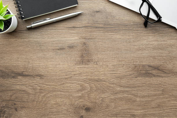 istock Wood office desk table with laptop computer, notebook and pen. Top view with copy space, flat lay. 1314289425
