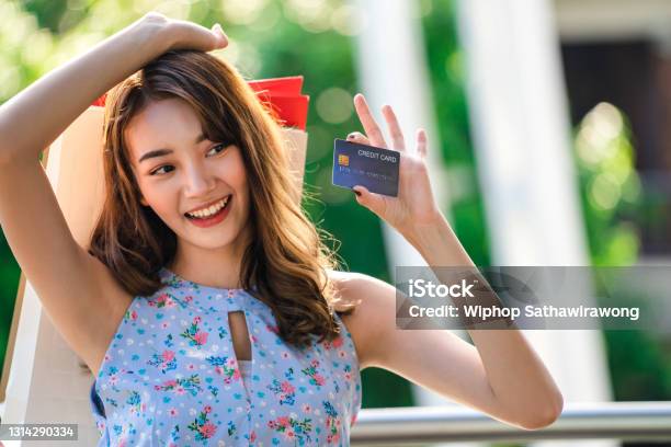 Asian Young Woman Shopper Stand At Outdoor And Pick Up Credit Card From ...