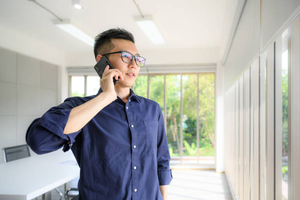 istock businessman using smartphone talking with colleague 1314290597
