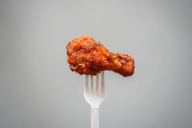istock fried chicken on plastic fork with grey background, fast food Concept with copy space. 1314293374