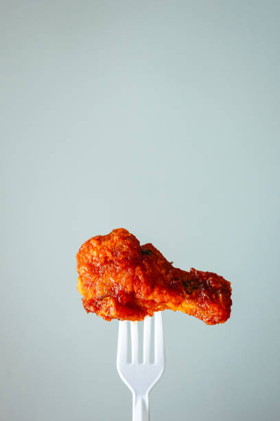 istock fried chicken on plastic fork with grey background, fast food Concept with copy space. 1314293381