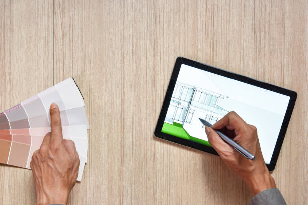 istock a top view of architect working desk with hand work color chart on equipment for drawings pens sketched idea on wood table, the concept of modern technology for architectural working on wooden table 1314294814