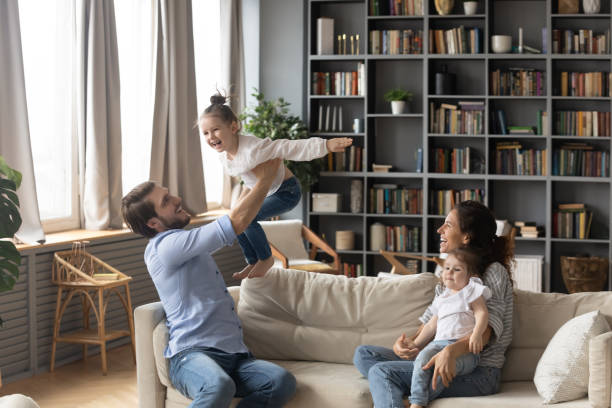 istock Happy parents have fun with little daughters at home 1314298972