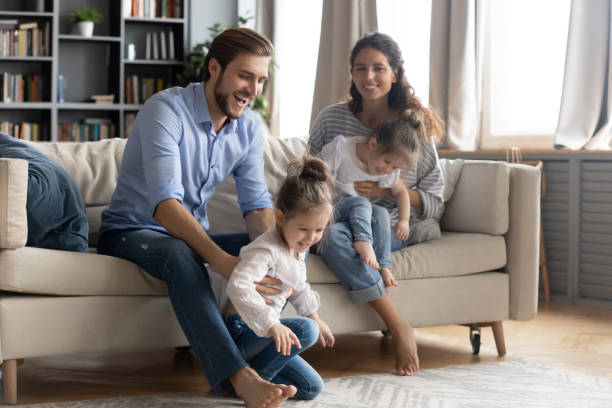 istock Happy parents play with small kids at home 1314299036