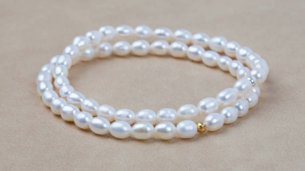istock Luxury elegant baroque pearl bracelets on beige textured leather background 1314299215