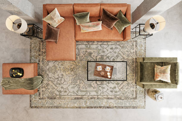 Modern apartment living room interior. Top view leather sofa, velvet armchair, coffee table, carpet, lamps and concrete floor. Copy space template. Render.