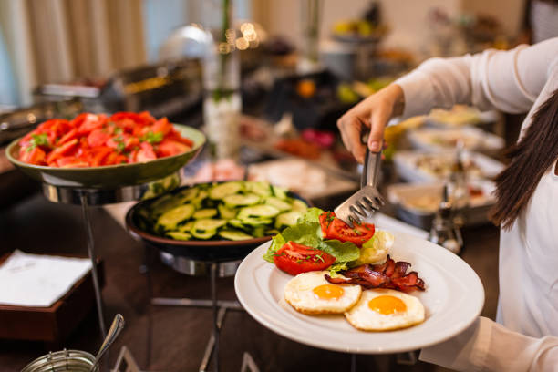 choosing breakfast at restaurant buffet - sideboard imagens e fotografias de stock