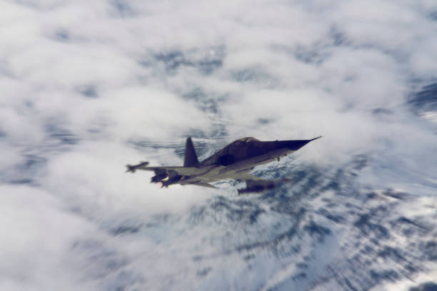 istock jet airplane flying over the clouds at sunset. 1314300747