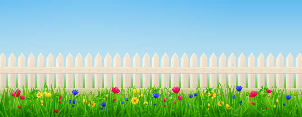 istock Wooden picket fence, flowers and green grass 1314301862
