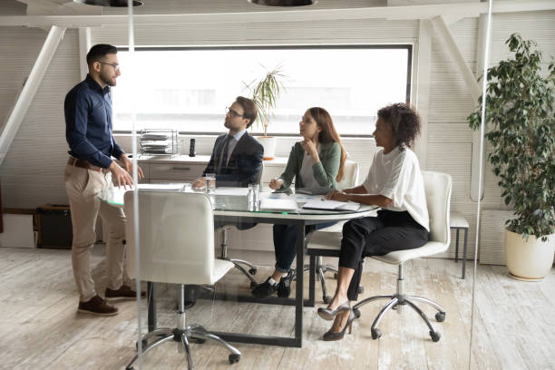 istock Arabian executive leading corporate briefing with diverse employees in boardroom 1314304064