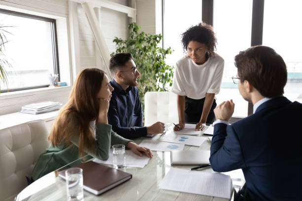 istock Diverse colleagues working with project statistics in boardroom together 1314304069