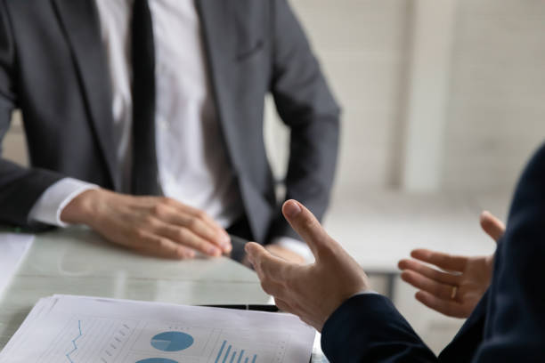 istock Close up business partners discussing project statistics at meeting 1314304115